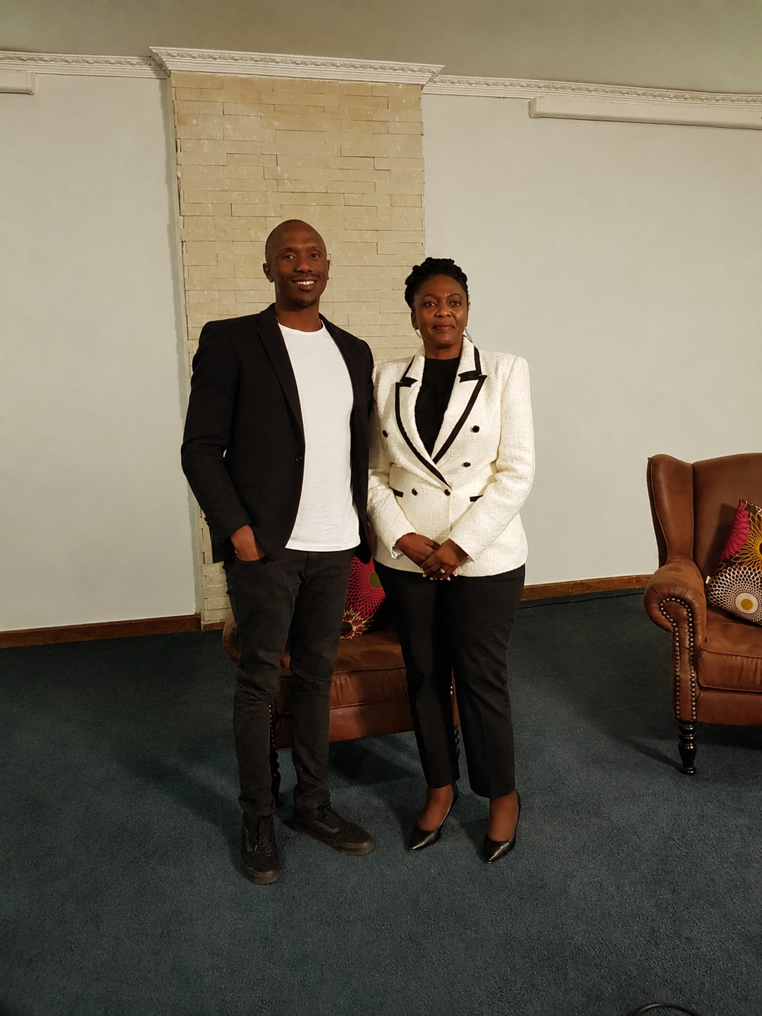 Thabang Motloung standing with Taelo Mojapelo at a leadership media feature setting
